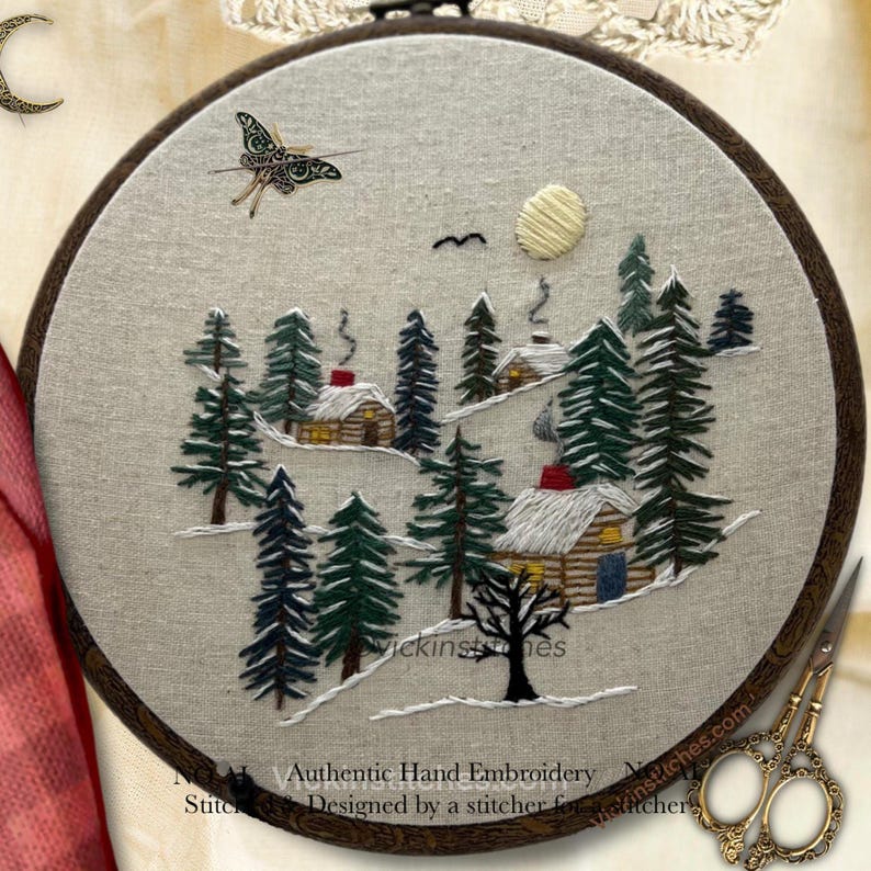 Embroidery kit featuring 3 cabins nestled in a-snowy pine woods