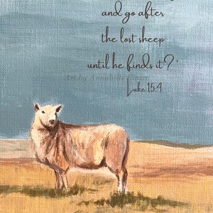 May include: A painting of a white sheep standing in a field with a blue sky in the background. The painting includes a quote from the Bible, Luke 15:4, which reads: "Does He not leave the ninety-nine in the open country and go after the lost sheep until he finds it?"