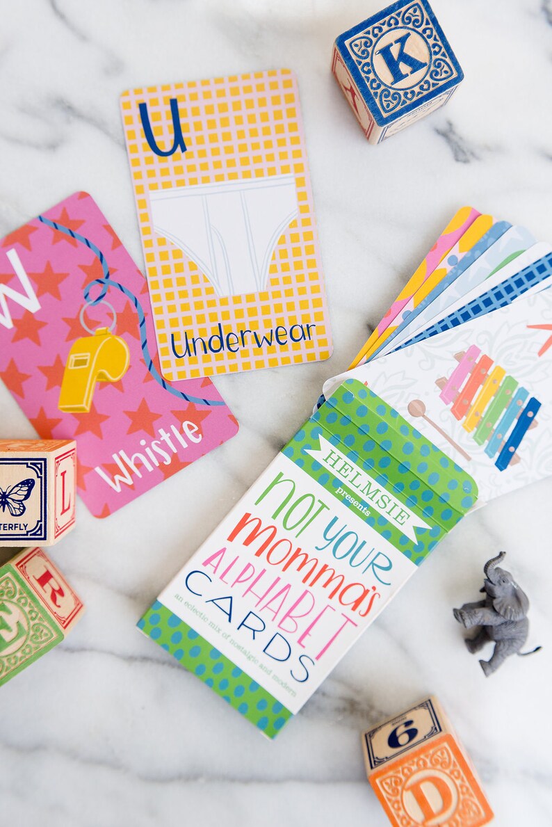 May include: A box of alphabet flash cards with a green, blue, and white polka dot pattern. The box says "Not Your Momma's Alphabet Cards" and "an eclectic mix of nostalgic and modern".