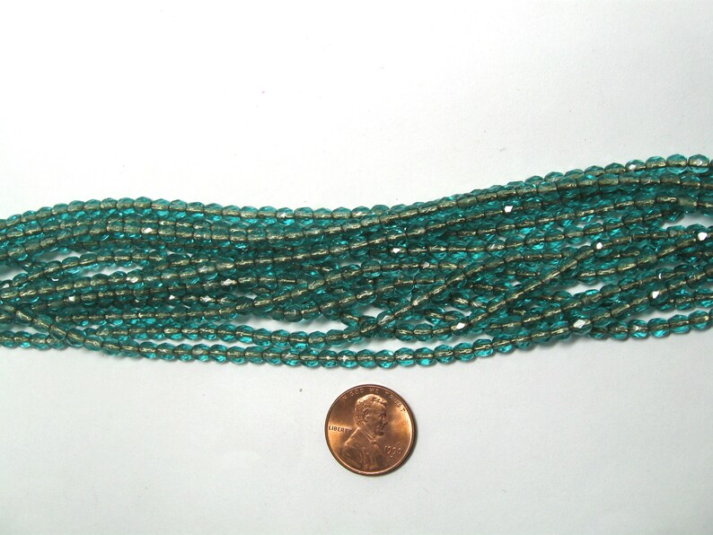 4mm Czech Fire Polish Beads Copper Lined Emerald Sold by the Half Mass