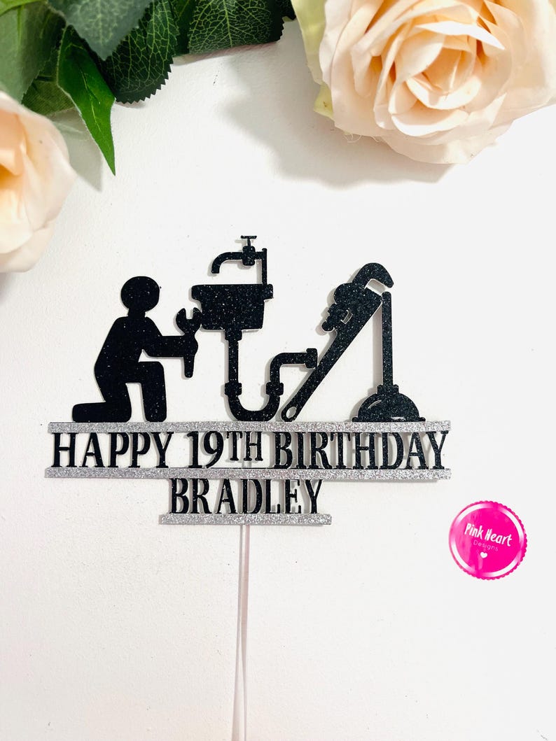 May include: Black and silver cake topper with a plumber silhouette, a sink, a wrench, and the text "Happy 19th Birthday Bradley".