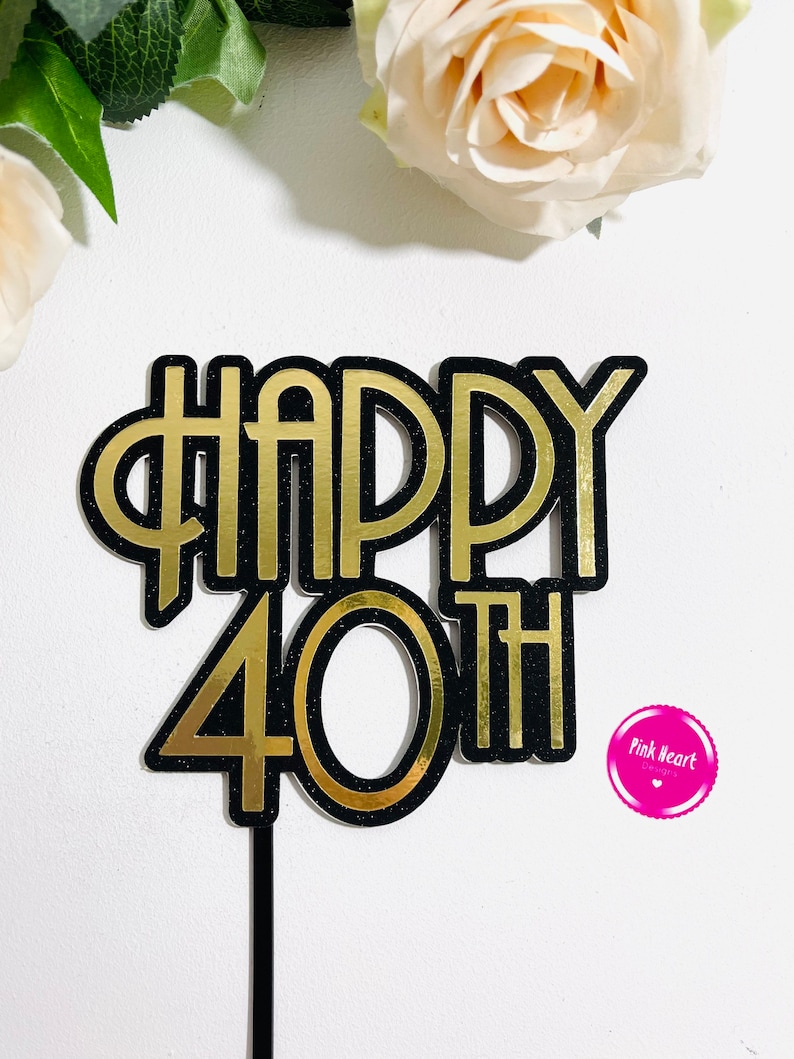May include: Black and gold glitter cake topper with the words "Happy 40th".