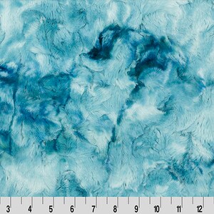 May include: A blue and teal faux fur fabric with a marbled pattern. The fabric has a soft, plush texture.