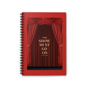 May include: Red spiral bound notebook with a red velvet curtain design and the text "Your Show Must Go On Dazzle Them!"