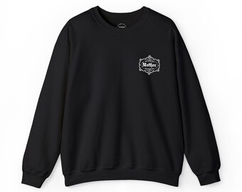 May include: Black crewneck sweatshirt with long sleeves. The sweatshirt features a white decorative emblem on the upper left chest with the word "Mother" in a stylized font. The sweatshirt is made of a soft material.