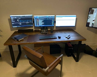 Dark oak coloured desk or dining table made with reclaimed scaffolding boards