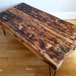 Charred wood upcycled pallet coffee table in burnt style and farmhouse unique style made with salvaged wood with industrial hairpin legs
