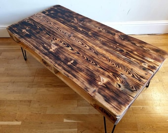 Charred wood upcycled pallet coffee table in burnt style and farmhouse unique style made with salvaged wood with industrial hairpin legs