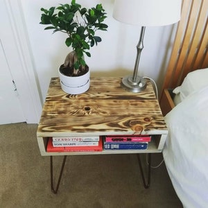 Reclaimed wood side table in rustic farmhouse style made with lightly charred pallet wood with urban industrial style copper hairpin legs