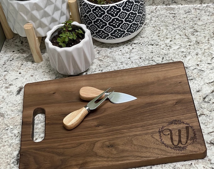 Custom walnut and maple cutting boards// custom wedding gifts // cutting board with initial and lasered wreath.