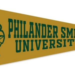 May include: A gold pennant with the words "PHILANDER SMITH UNIVERSITY" in dark green. The pennant features a dark green cougar head logo on the left side and dark green trim and ties.