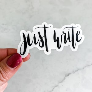 May include: A white sticker with black lettering that says "just write".
