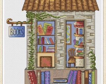 May include: A cross-stitch pattern of a small stone building with a sign that says "BOOKS". The building has a brown roof, a window with bookshelves, and a chair inside. There are stacks of books outside the building.