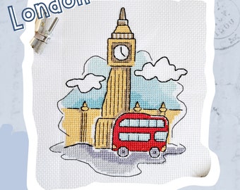 May include: A cross-stitch design featuring Big Ben, a red double-decker bus, and clouds against a blue sky. The design is titled "London".
