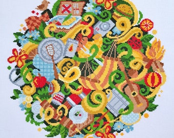 Könnte beinhalten: Ein farbenfrohes Kreuzstich-Stickmuster mit verschiedenen Objekten, darunter Blumen, Blätter, ein Vogel, ein Haus, ein Korb, eine Gießkanne und ein Heißluftballon. Das Design ist kreisförmig und hat einen weißen Hintergrund.