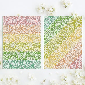 May include: Two cross-stitch patterns featuring intricate floral designs with a gradient color scheme. The patterns are framed and displayed against a white background.