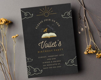 May include: Black invitation card with gold lettering for a birthday party. The card features a book with a sun and clouds in the background. The text reads "Please join us for Voilet's Birthday Party. Sunday, February 19th 3PM-8PM Dinner & Drinks 123 Basgiath St. RSVP 555-555-5555"