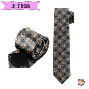 May include: A gray necktie with a repeating pattern of cat faces. The cat faces are a mix of black, white, and orange.