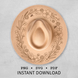 Può includere: Un cappello fedora beige con un design floreale e di api inciso sul bordo. Il cappello ha una corona arrotondata e un'ampia tesa. Il testo "PNG • SVG • PDF DOWNLOAD IMMEDIATO" è in basso.