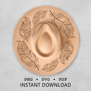 May include: A tan fedora hat with a decorative feather design. The hat features a circular brim with six brown, detailed feather illustrations. The text "PNG • SVG • PDF INSTANT DOWNLOAD" is printed at the bottom.