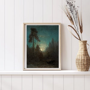 May include: A framed painting of a moonlit forest scene. The painting features a tall, dark tree in the foreground, with a full moon shining through the branches of the trees in the background. The sky is a deep blue, and the forest is bathed in a soft, ethereal light.