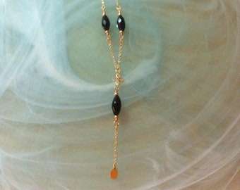 Long necklace with faceted black Onyx marquises pendant on a Gold plated flower chain ending in a Gold-plated drop