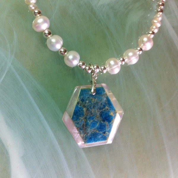 Intarsia pendant with a fine Apatite pearl stone and hexagon-cut mother-of-pearl, suspended from a necklace of freshwater pearls