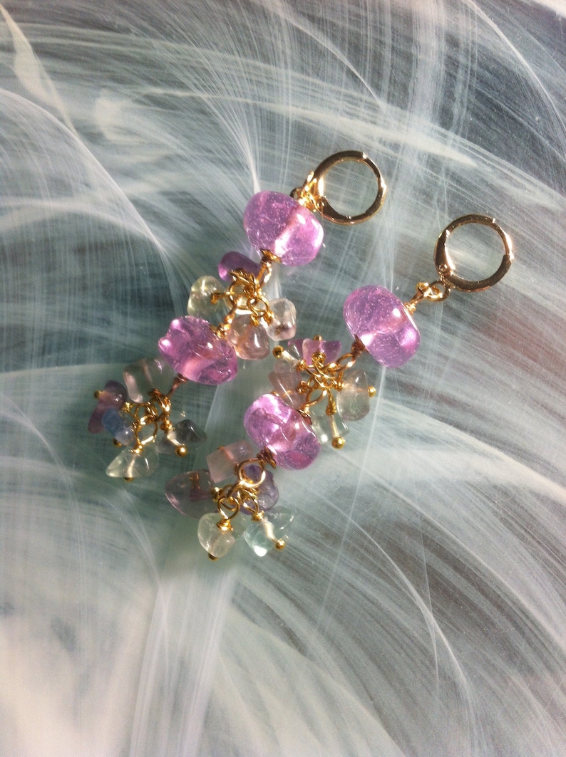 May include: A pair of dangle earrings with pink and green gemstone beads and gold accents.