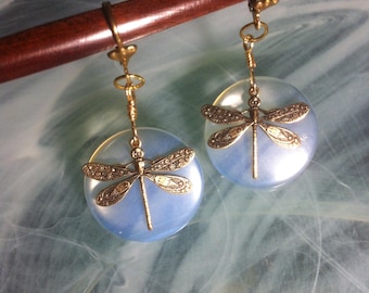 Earrings with Opalite Quartz discs with blue reflections and a resting golden brass dragonfly