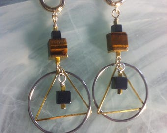 Mixed metal earrings in a New Age style of a gold plated triangle on brass in a stainless steel circle with Tiger's Eye and Hematite cubes