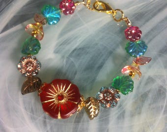 Romantic and magical fantasy carnival cocktail bracelet with multicolored garden flowers and pink and gold Czech glass lilies with AB leaves