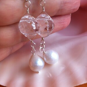Earrings composed of clear Swarovski crystal and large lustrous Edison pearls suspended from a 925 Sterling silver wire