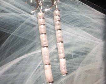 Avant-garde earrings featuring a stack of transparent white jade, discs, and hoops in shiny silver-plated stainless steel