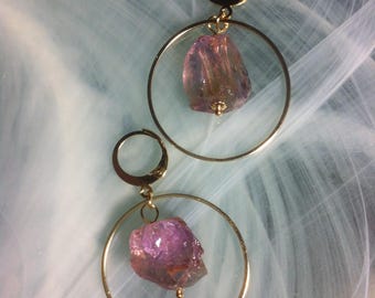 Earrings featuring raw Ametrine stones in a gold plated 14K circle hoops in a minimal style design