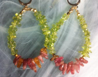 Large oval hoop earrings strung with Peridot nugget beads and pink Tourmalines with faceted Hematite beads plated in gold