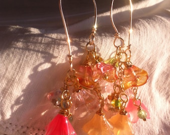 Handcrafted double-prong earrings featuring bouquets of multicolored Czech glass flowers suspended from a delicate chain and gold hoops