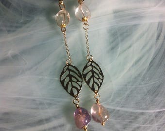 Long, flowing, and airy earrings with raw ametrine stones dangling from a 14K gold-plated filigree leaf, embellishing these earrings