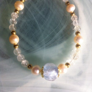bracelet with a large central Aquamarine dichroic glass bead while opalescent highlights and Aquamarine pearls, freshwater pearls
