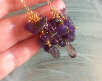 Earrings with amethyst nuggets connected with jump rings on a fine gold-plated chain and a light amethyst Swarovski crystal drop