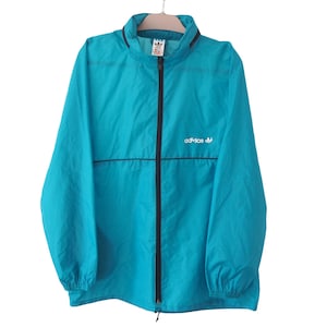 Vintage ADIDAS Jacket Full Zip Size L blue sport windbreaker hides in a pocket