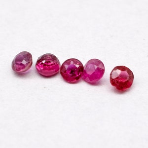 May include: Six round, faceted, ruby red gemstones on a white background. MPGemshop Precious & Semi-precious Gemstones www.mpgemshop.online