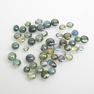 Sapphire Cabochons in an assorted Packet Size 2 to 4mm round (approx 10.45cts) As photographed.