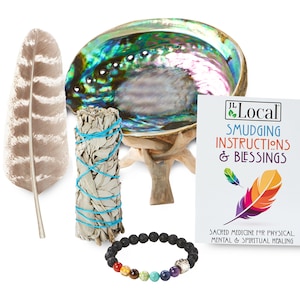 May include: A smudging kit containing a white sage smudge stick, abalone shell, feather, and a chakra bracelet. The kit also includes a card with instructions and blessings. "Sacred Medicine for Physical, Mental & Spiritual Healing" is printed on the card.