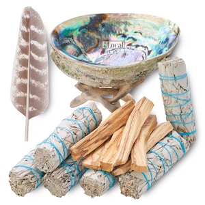 May include: A set of smudging tools including white sage bundles, palo santo sticks, a feather, and an abalone shell with a wooden stand. The shell is iridescent with shades of blue, green, and purple.