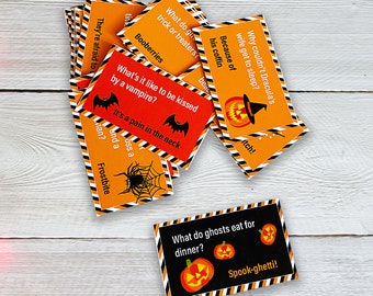 May include: A set of orange and black Halloween-themed cards with jokes and puns printed on them. The cards feature a variety of Halloween icons, including pumpkins, bats, and spiders. The text on the cards includes phrases like "What do ghosts eat for dinner?" and "Why couldn't Dracula's wife get to sleep?"