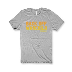 May include: A gray t-shirt with the text "Back Off War Child" in orange and yellow.