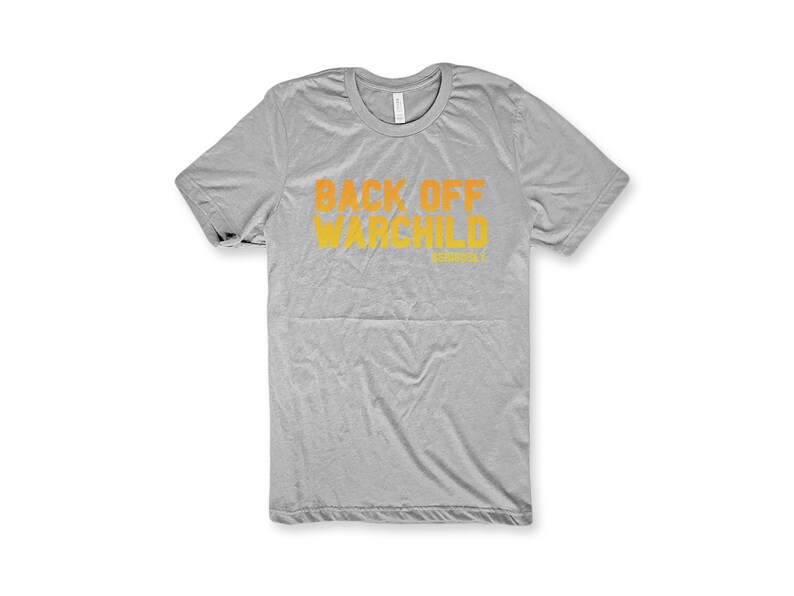 May include: A gray t-shirt with the text "Back Off War Child" in orange and yellow.