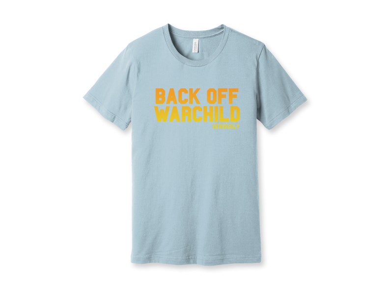 May include: A light blue t-shirt with the text "Back Off Warchild" printed in orange on the front.