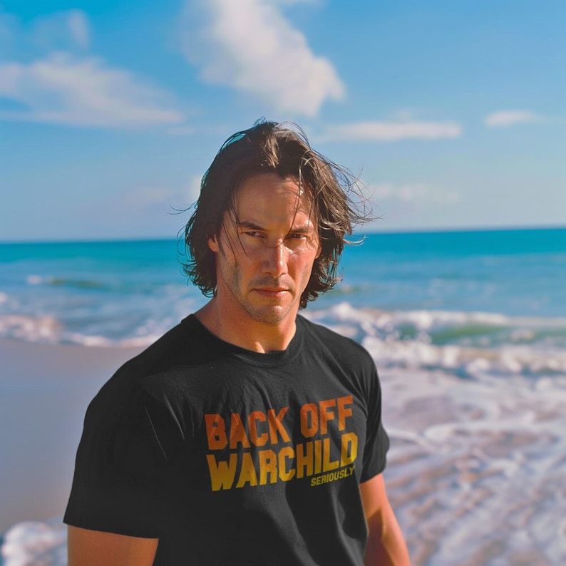 90s action movie shirt Back off warchild Keanu Reeves beach Black Bella Canvas Short Sleeve T-shirt