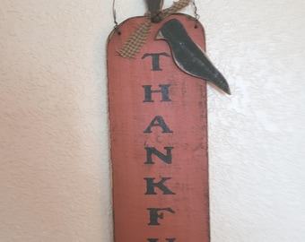 Tall pumpkin with crow.  The word "thankful" is stenciled down the front.  Handcrafted wood hanging sign.